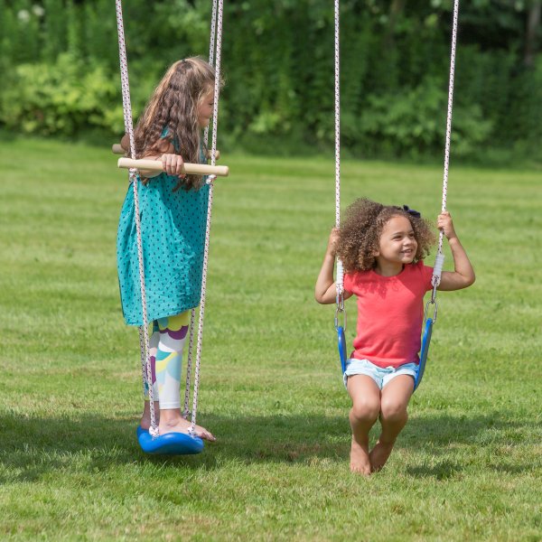 Kids playing on a swingset with various types of swings